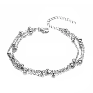 Multi-layer silver bead chain anklet with lobster clasp and extension chain on white background