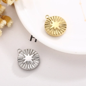 Macro detail of gold and silver sunburst pendants with embossed eight-pointed stars