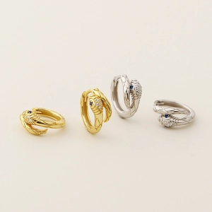 Snake hoop earrings in gold and silver finish with sparkling zircons and blue stone eyes
