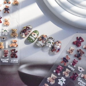 Detailed 3D embossed nail stickers featuring various cute colorful bear doll designs