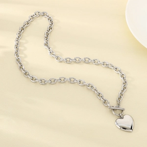 Detailed view of silver heart pendant with thick chain and stylish OT toggle clasp