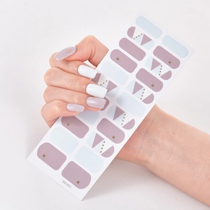 Detail showing purple and white geometric nail stickers with small gold studs
