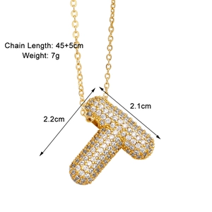 Detail view of gold letter T pendant necklace with cubic zirconia and size measurements