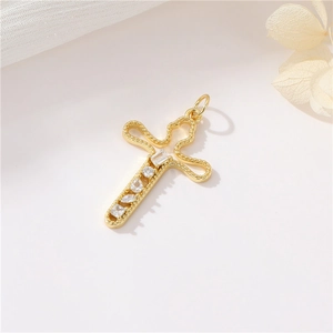 Vintage 14K gold plated cross pendant with sparkling zircon on soft beige fabric
