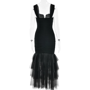 Detail of black patchwork midi dress showing back pleats and multilayered tulle fishtail hem