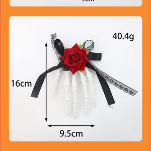 Detail view of Halloween skeleton hand hair clip with red rose and dimensions 16cm by 9.5cm