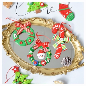 Detailed flat lay of resin Christmas ornaments on a vintage mirror including wreath and candy cane