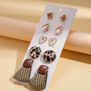 Detailed set of five vintage stud earrings with leather, leopard print, and houndstooth