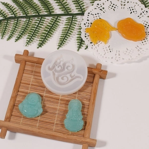Macro view of Buddha and safety buckle silicone mold with DIY resin finished pendants