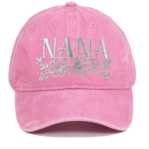 Close-up of gray NANA floral embroidery on a washed pink cotton baseball cap fabric