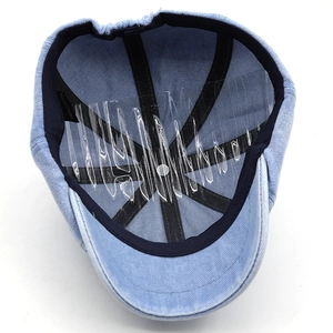 Detail view of cotton denim octagonal cap interior with 100% cotton label and lining