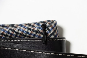 Detail of plaid midi dress featuring high-density twill fabric and hidden black zipper