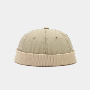 Detail of beige corduroy patchwork docker hat with ribbed knit edge and ventilation eyelets