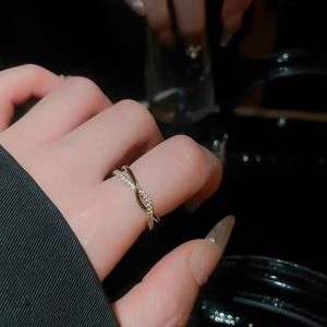 Detailed close-up of double-layer gold cross ring with micro-pave cubic zirconia stones