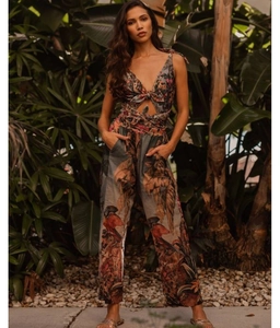Detail of tropical print swimsuit featuring deep V-neck and waist hollow tie design