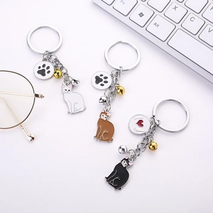 Detailed view of metal cat keychains with paw prints, bells and colorful pendants