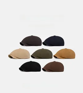 Vertical collage showing seven colors of cotton flat caps in classic British style