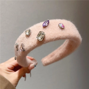 Detail of pink faux fur headband with embedded multi-colored crystal rhinestones and gems