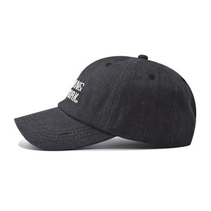 Close-up of premium washed denim baseball cap featuring high-quality white embroidery detail