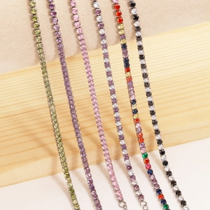Macro shot of colorful tennis bracelets with round zircons hanging on a wooden stand