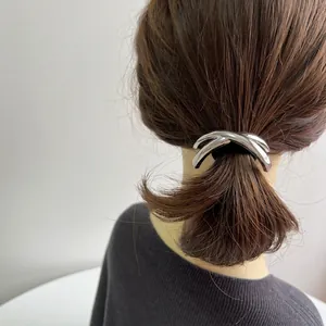 Polished silver alloy knot hair ring on a ponytail showcasing minimalist metallic style