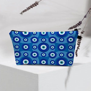 Detail of waterproof evil eye makeup bag on display stand with natural shadows