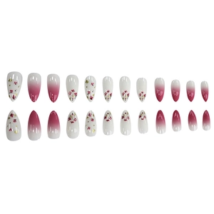 Detail of 24pcs almond press-on nails with pink floral patterns and gold foil flakes