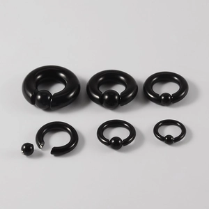 Macro view of black stainless steel captive bead rings in various sizes for body piercing