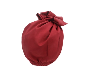 Detailed view of dark red turban hat with front knot and elastic pleated fabric texture