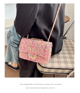 Close-up of pink tweed shoulder bag with golden twist lock and metal chain strap