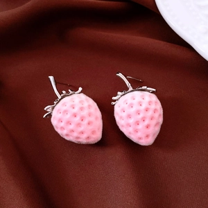 Macro view of pink flocked strawberry stud earrings with detailed silver leaf stems