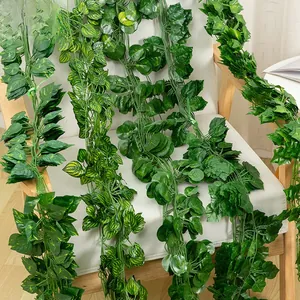 Artificial green leaf vines hanging over a chair for home wall and ceiling decoration