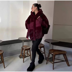 Fashionable burgundy jacket with faux fur splicing and ribbed knit sleeves on a model