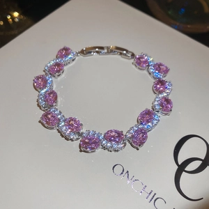 Detailed macro view of an oval pink halo crystal bracelet with sparkling cubic zirconia