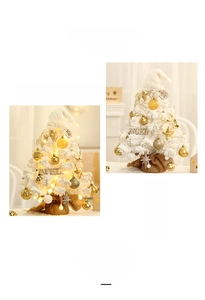 Detail of mini flocked Christmas trees with warm LED lights and rustic burlap base