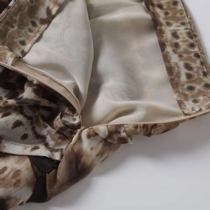 Close-up of earth-tone leopard print fabric with invisible zipper detail on dress