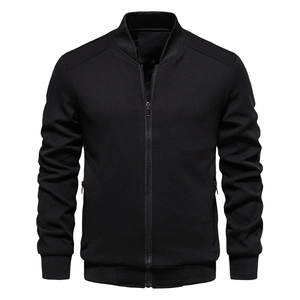 Close-up of black bomber jacket with textured waffle fabric and ribbed stand-up collar