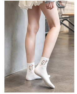 Close-up of white cotton socks with cartoon bear embroidery and Got very rich text