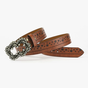 Brown faux leather punk belt with star cutouts and a large rhinestone buckle on white