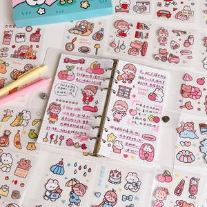 Close-up of cute cartoon stickers on a binder notebook with colorful girl and animal patterns