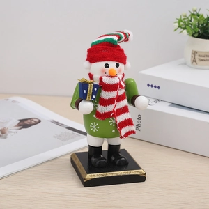Close-up of wooden snowman nutcracker decoration with knitted scarf on a festive desk