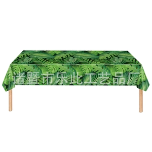 Rectangle table with tropical palm leaf pattern tablecloth and natural wooden legs
