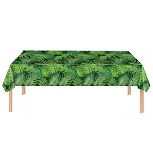 Table rectangulaire avec nappe à motif de feuilles de palmier et pieds en bois