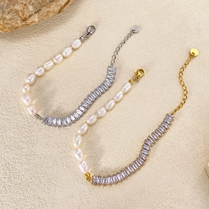 Elegant pearl and baguette-cut zircon bracelets in gold and silver finish on sand texture