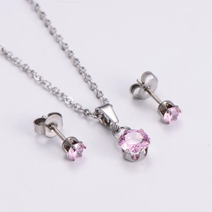 Macro shot of silver-tone jewelry set with round pink cubic zirconia pendants and studs