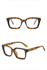 Macro view of tortoise shell square glasses frame with classic dot stud detailing
