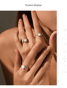 Three gold vintage opal rings featuring square, round, and oval cuts on female model