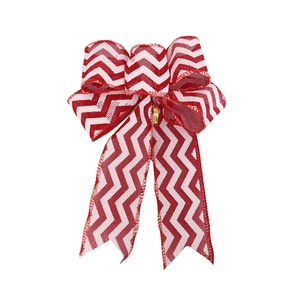 Detailed view of handmade burlap Christmas bow with red and white chevron pattern