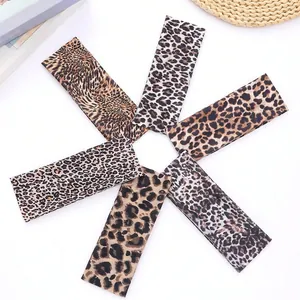 Set of 6 leopard print satin hair bands with diverse patterns on white background