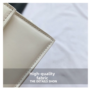 Close-up of premium beige leather bag showing precise stitching and fine texture details